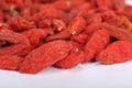 Traditional Chinese herbs dried wolfberry close up. Goji berryes pile, over white isolated.