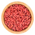 Goji Berries in wooden bowl isolated.