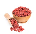 Goji berries in a wooden bowl isolated on white Royalty Free Stock Photo