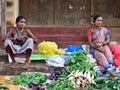 Hindu women, dressed in traditional dresses, are selling vegetables
