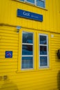 GOL, NORWAR, APRIL, 02, 2018: Outdoor view of wooden yellow building with a glass window, and informative sign of not Royalty Free Stock Photo