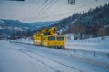 GOL, NORWAR, APRIL, 02, 2018: Winter outdoor view of huge yellow truck bane nor, responsible for owning, maintaining Royalty Free Stock Photo