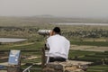 Religious man observing the Israeli Syrian border with binoculars in Golan Heights, Isra