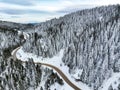 Golcuk - Bolu - Turkey, winter snow during snowfall. Travel concept drone photo. Highway, road in snowy tree landscape