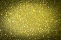 Gold abstract background with dark vignette, defocused Christmas lights. Festive concept. Selective focus. Royalty Free Stock Photo