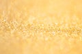 Gold abstract bokeh glitter texture background, filled with shiny gold glitter background. selective focus Royalty Free Stock Photo