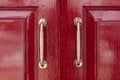 Aluminum door handle and red wood door Royalty Free Stock Photo
