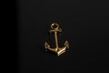 Gold anchor on black background