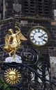 Gold Angel On a Church Gate with the Church Clock in the Background