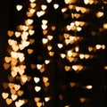 Gold background bokeh lights heart, valentine backgrounds, blurred sparkle for night backdrop Royalty Free Stock Photo