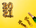 2021 gold balloons and Champagne bottle and flute glasses Royalty Free Stock Photo