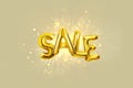 Gold balloons sale with golden fireworks and explosion on beige background. Sale flies with sparks, creative idea. Promotion Royalty Free Stock Photo