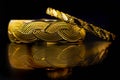 Gold bangle jewellery on black background Royalty Free Stock Photo