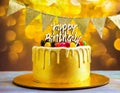 A gold banner with a happy birthday message decorates the birthday cake