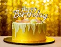 A gold banner with a happy birthday message decorates the birthday cake