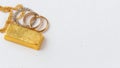 Gold Bar, Chains, and Rings on White Background with copy space Royalty Free Stock Photo