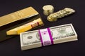 Gold bar and coins on black Royalty Free Stock Photo