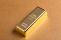 Gold bar, ingot on yellow background Royalty Free Stock Photo