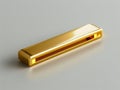 A gold bar shaped usb flash drive sitting on a gray surface Royalty Free Stock Photo
