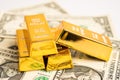Gold bar on US dollar banknotes money and graph, economy finance exchange trade investment concept