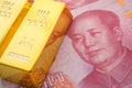 Gold bars on Chinese yuan bill banknotes background. Concept of gold future trading, online asset commodity trading or buy gold