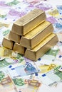 Gold bars on heap of euro notes Royalty Free Stock Photo