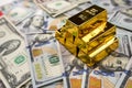 gold bars over dollar money bills, investment saving concept Royalty Free Stock Photo