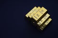 Gold bars stacked in a pyramid shape. Shiny precious metals for investments or reserves.