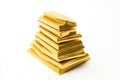 Gold bars stacked in a pyramid on a white background. Precious metal. AI generated. Royalty Free Stock Photo