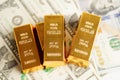 Gold bars on US dollar banknote money, finance trading investment business currency concept