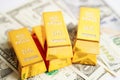 Gold bars on US dollar banknote money, finance trading investment business currency concept