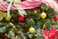 Gold bauble christmas tree red garland and lights Royalty Free Stock Photo