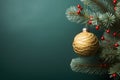 Gold bauble hanging on a Christmas tree branch on the right. Green background. Side view.Christmas banner with space for your own Royalty Free Stock Photo