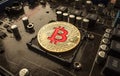 Gold Bit Coin BTC coins on the motherboard. Bitcoin is a worldwide cryptocurrency and digital payment system called the first dec