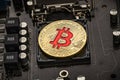 Gold Bit Coin BTC coins on the motherboard. Bitcoin is a worldwide cryptocurrency and digital payment system called the first dec