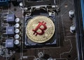 Gold Bit Coin BTC coins on the motherboard. Bitcoin is a worldwide cryptocurrency and digital payment system called the first dec