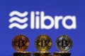 Bitcoin Coin with the Facebook`s Libra Crypto Coin logo Royalty Free Stock Photo