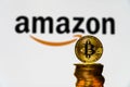 Gold Bitcoin coins with the Amazon logo