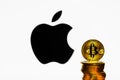 Gold Bitcoin coins with the Apple logo