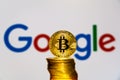 Gold Bitcoin coins with the Google logo on background Royalty Free Stock Photo