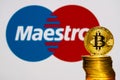 Gold Bitcoin coins with the maestro logo on background Royalty Free Stock Photo