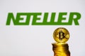 Gold Bitcoin coins with the Neteller logo Royalty Free Stock Photo