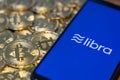 Bitcoin Coin with the Facebook`s Libra Crypto Coin logo