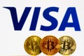 Gold Bitcoin coins with the Visa logo