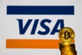 Gold Bitcoin coins with the Visa logo