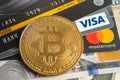 Bangkok, Thailand, July 9, 2021, Gold bitcoin with credit card on US dollar banknotes for electronic worldwide exchange virtual