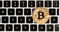 Gold bitcoin cryptocurrency with a latop Royalty Free Stock Photo