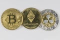 Gold Bitcoin, Etherium and Ripple Tokens in a row