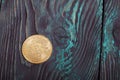 Gold bitcoin on painted pine boards