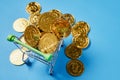 Gold Bitcoin placed in a small shopping cart. Digital currency concepts can be used to make online purchases.